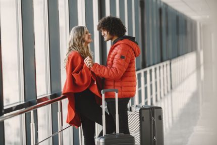 Travelers with luggage at airport terminal