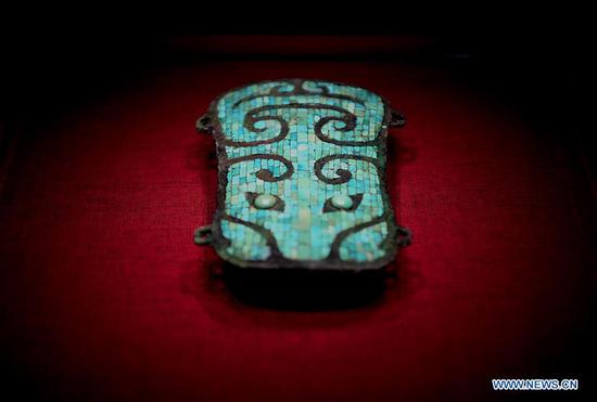 Sancai glazed pottery detail showing amber green cream and blue glaze pooling and run-off