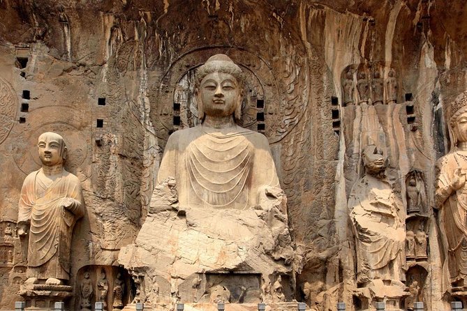 A close-up of Tang Dynasty sculptures at Longmen Caves China, showing their realistic form and detailed drapery.